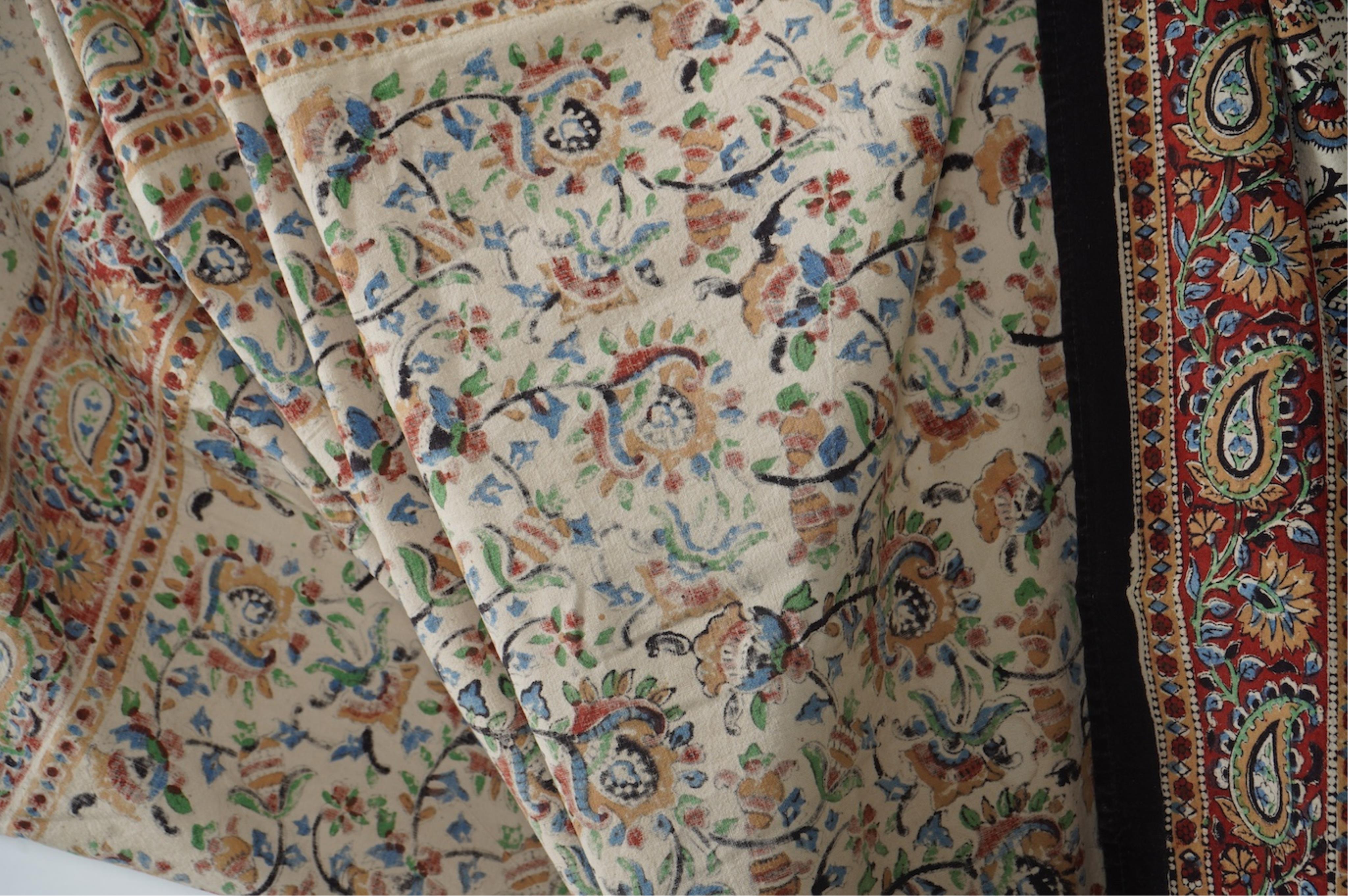 Two late 20th century large Indian block printed cotton bedcovers. One printed with brown borders, the other with brick red borders, both with large central panels designed in a classical Indian floral vining design. Bro